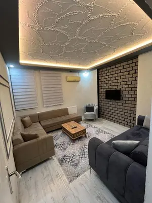 a living room with a couch and a table at Poyraz suit in Bursa