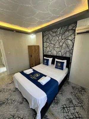 a bedroom with a bed with blue and white pillows at Poyraz suit in Bursa