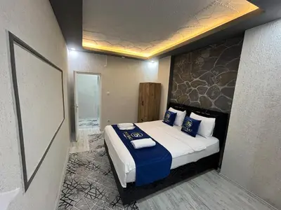a bedroom with a large bed with blue pillows at Suit 2 in Bursa