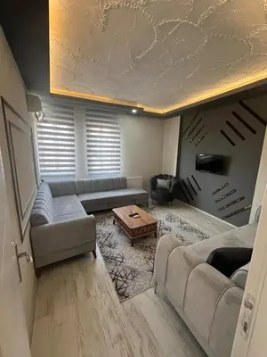 a living room with a couch and a table at Suit 4 in Bursa