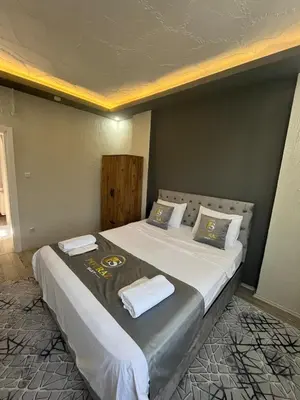 a bedroom with a large bed with towels on it at Suit 4 in Bursa