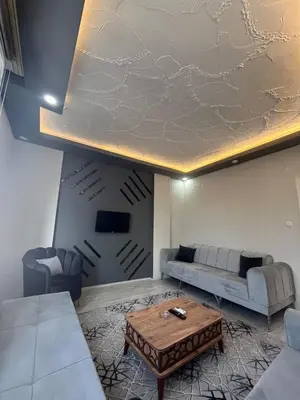 a living room with a couch and a table at Suit 4 in Bursa