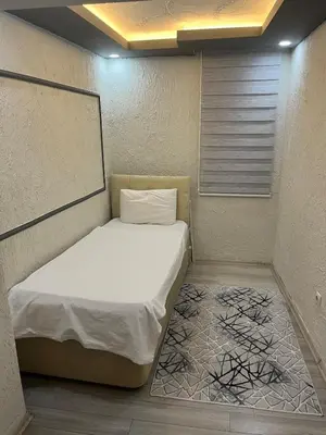 a small bed in a small room with a white mattress at Poyraz suit in Bursa