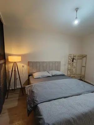 a bedroom with a bed and a lamp in it at White Lotus Suites in Istanbul