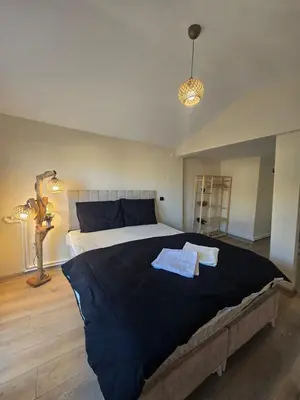 a bedroom with a large bed with two towels on it at White Lotus Suites in Istanbul