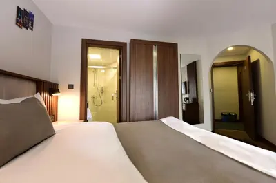 a bedroom with a large bed and a mirror at Hotel Öncü in Istanbul