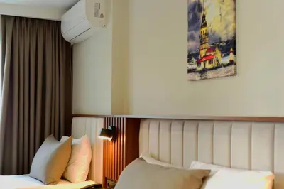 a bedroom with a bed with white sheets and pillows at Hotel Öncü in Istanbul