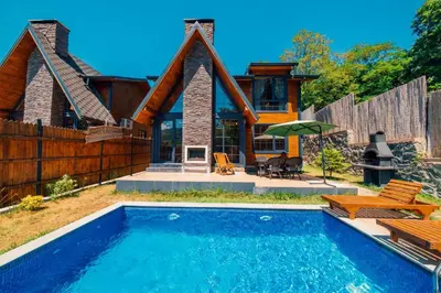 a house with a swimming pool in front of a house at Sapanca Grandwooden Deluxe in Sapanca