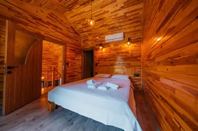 a bedroom with a bed in a wooden cabin at Sapanca Grandwooden Deluxe in Sapanca