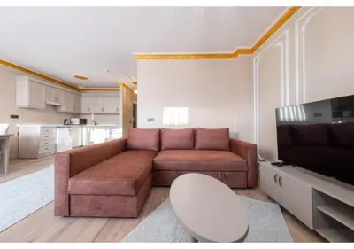 a living room with a brown couch and a chair at Taksim Studio Apart in Istanbul