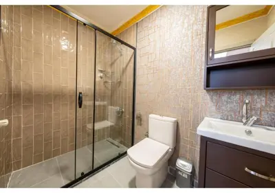 a bathroom with a shower and a toilet and a sink at Taksim Studio Apart in Istanbul