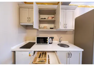 a small kitchen with a sink and a microwave at Taksim Studio Apart in Istanbul
