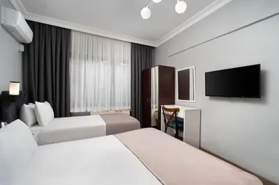 a hotel room with two beds and a flat screen tv at Galley Port in Istanbul