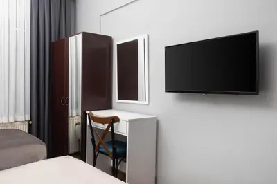 a bedroom with a desk with a tv and a chair at Galley Port in Istanbul