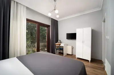 a bedroom with a bed and a window and a desk at Galley Port in Istanbul