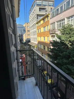 a balcony with a view of a city with buildings at Cihangir Galataport Hotel in Istanbul