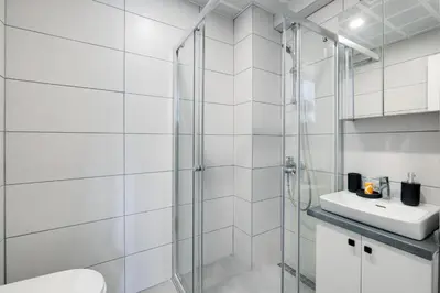 a bathroom with a shower and a toilet and a sink at Newly Constructed in Kadikoy Quake-Resistant-AC in Istanbul