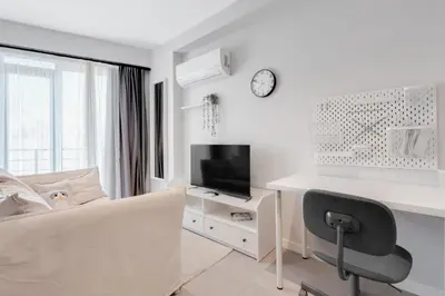 a white room with a couch and a desk and a tv at Newly Constructed in Kadikoy Quake-Resistant-AC in Istanbul