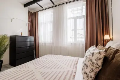 a bedroom with a bed with a dresser and a window at Lovely City Apartment Steps Away from Galata Tower in Istanbul