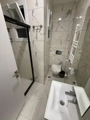 a white bathroom with a sink and a toilet at Galata Green Apple Apart in Istanbul