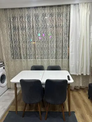 a white table with four chairs in a room at Galata Green Apple Apart in Istanbul