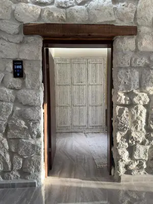 an opening in a stone wall with a door at Magical House Hotel in Çatalca