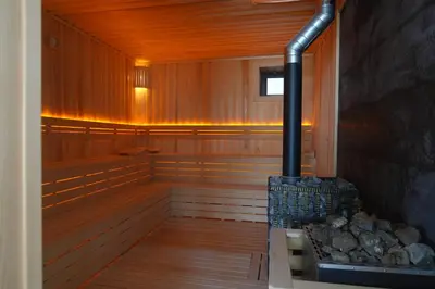 an empty sauna with a stove in the middle at Magical House Hotel in Çatalca