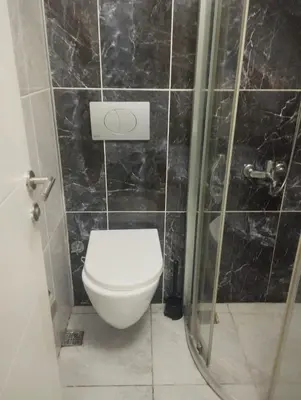 a bathroom with a toilet and a shower at Şişli Suites - Room49 in Istanbul