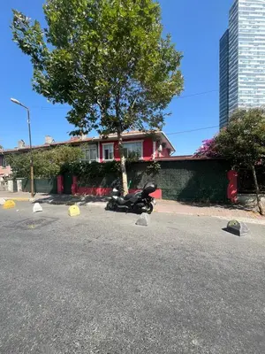 a motorcycle parked in a parking lot next to a house at Şişli Suites - Room45 in Istanbul