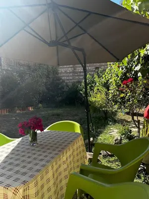 a table with a vase of flowers on a table under an umbrella at Welcome to the presence of history! in Istanbul