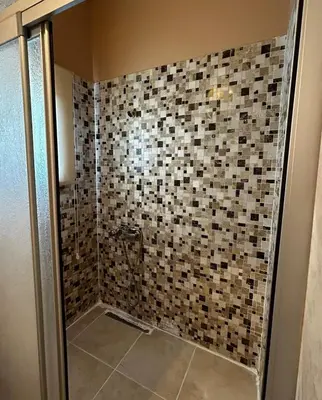 a bathroom with a shower with a tiled wall at Welcome to the presence of history! in Istanbul