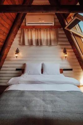a bedroom with two beds in a attic at Rast Sapanca Bungalov in Sakarya