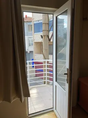 a sliding glass door with a view of a balcony at Otel in Kumbağ
