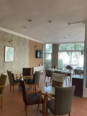 a restaurant with tables and chairs in a room at Otel in Kumbağ