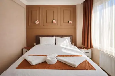 a bedroom with a bed with towels on it at Ayasofya Bella Vista APART in Istanbul