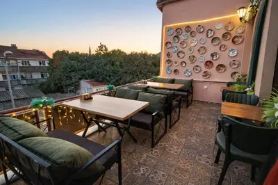 a patio with tables and chairs and plates on a wall at Ayasofya Bella Vista APART in Istanbul