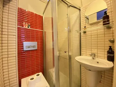a bathroom with a shower and a sink and a toilet at Charming Vintage 3BR in the Heart of Beyoğlu in Istanbul