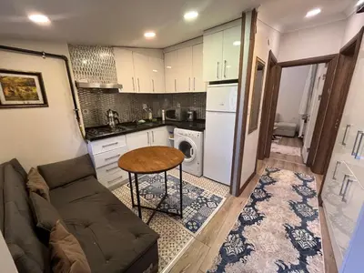 a living room with a couch and a table in a kitchen at Mutlu flat in Istanbul
