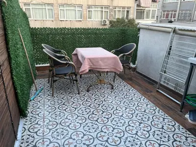 a patio with a table and chairs on a balcony at Mutlu flat in Istanbul