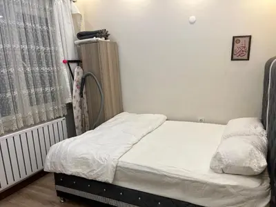 a small bedroom with a bed and a window at Mutlu flat in Istanbul