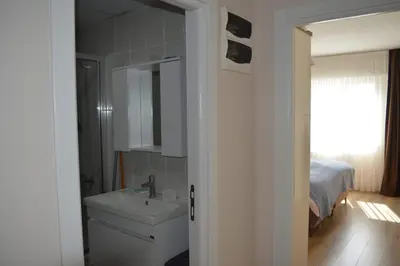 a bathroom with a sink and a mirror and a bed at King Suite SN20 in Esenyurt