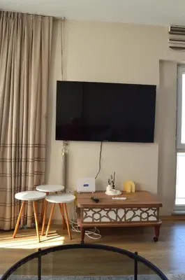 a living room with a large flat screen tv on the wall at King Suite SN20 in Esenyurt