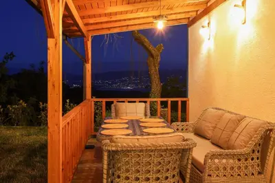a patio with a table and chairs on a porch at ayrıkvadi panorama in Serdivan