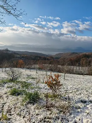 a snow covered field with trees in the distance at ayrıkvadi panorama in Serdivan