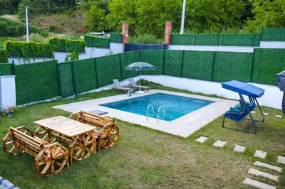 a swimming pool with a picnic table and an umbrella at ayrıkvadi panorama in Serdivan