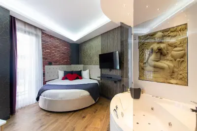 a bedroom with a bed and a bath tub at Nomad Hub Suit İstanbul in Istanbul