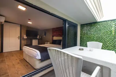 a bedroom with a bed and a table and chairs at Nomad Hub Suit İstanbul in Istanbul