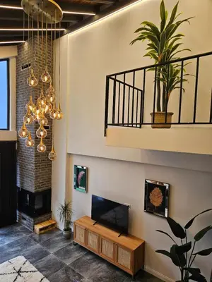 a living room with a fireplace and a chandelier at Sapanca modern in Sapanca
