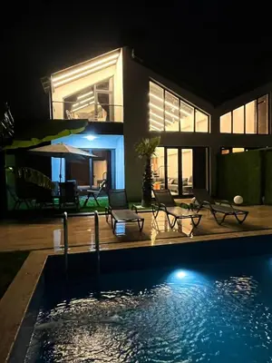 a house with a swimming pool at night at Sapanca modern in Sapanca