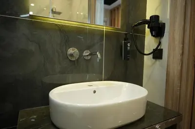 a white sink in a bathroom with a mirror at Kent Room Hotel in Kapaklı